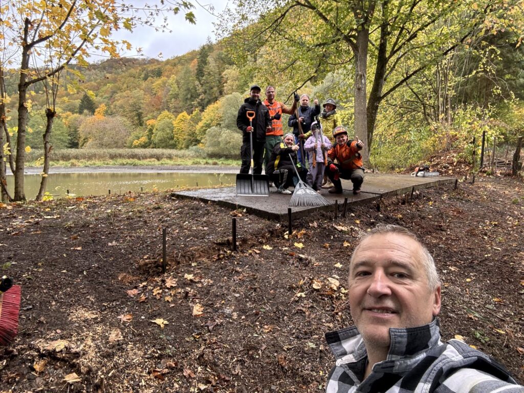 Gruppenfoto der Helferinnen und Helfer vor dem freigelegten Teichblick